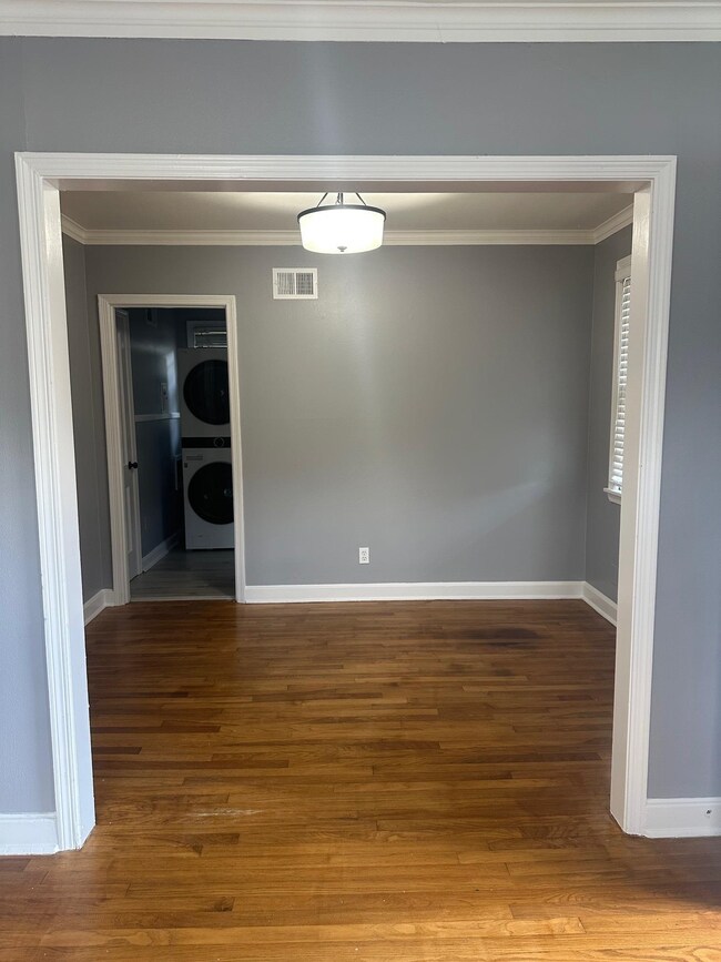 Spare room with stacked washer and clothes dryer, 