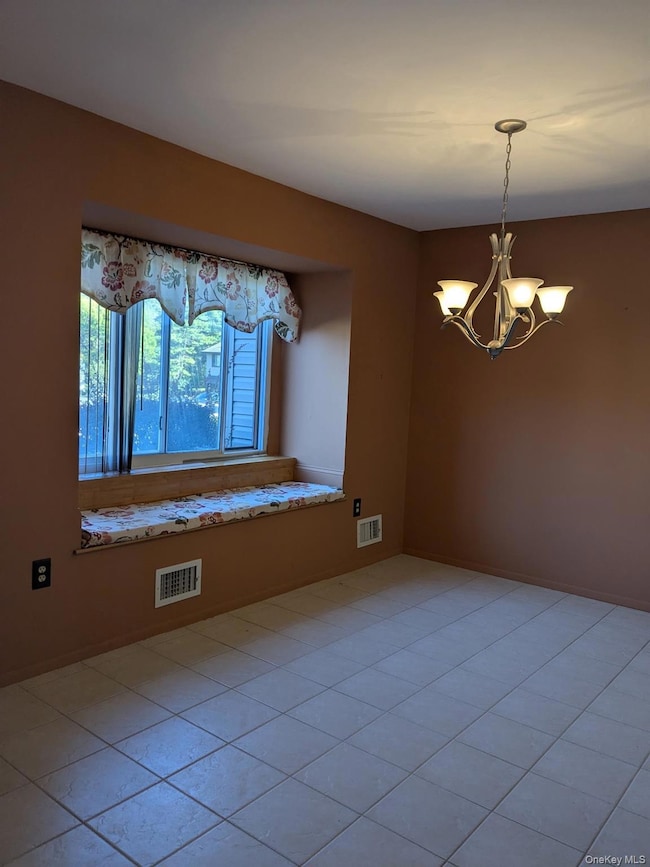 Dining Area with a chandelier and light tile patterned flooring