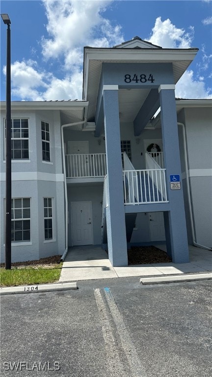 View of property with uncovered parking