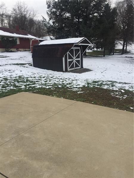 LEVEL CONCRETE PATIO OFF OF SUNROOM-STORAGE SHED F