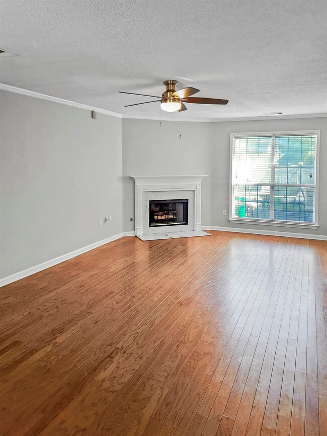 Living room features hardwood floors, floor-to-cei