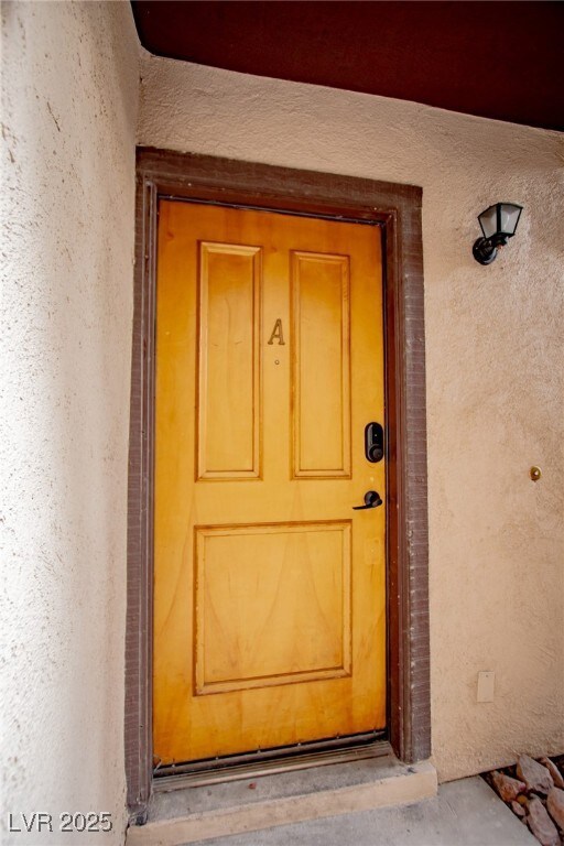 View of exterior entry featuring stucco siding