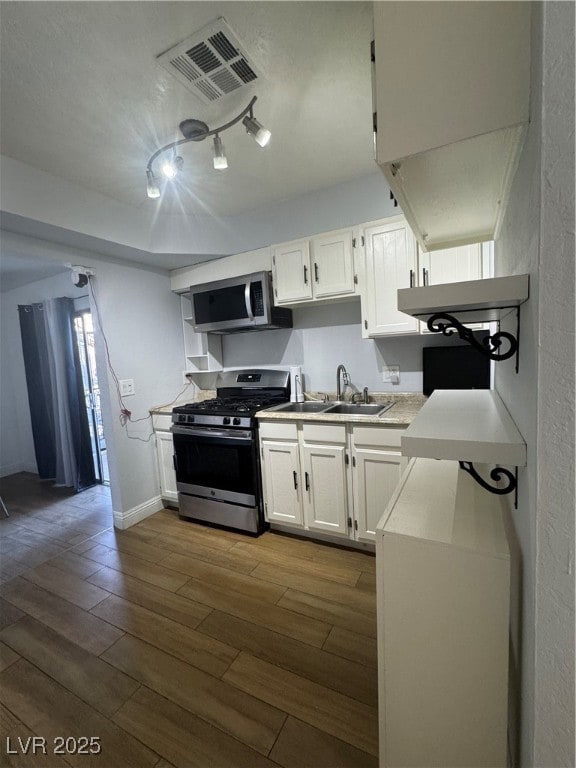Kitchen with dark wood-style floors, white cabinet