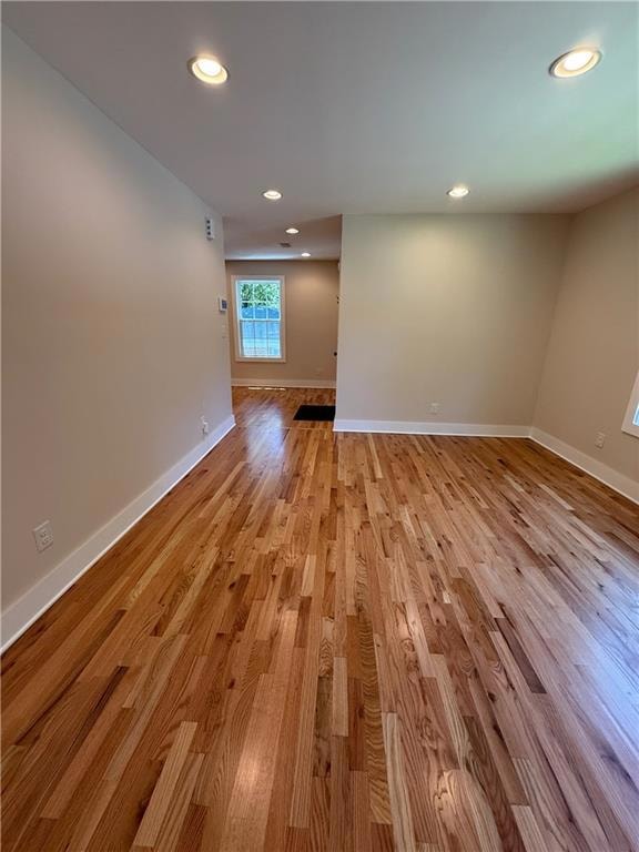 Gorgeous new hardwood floors grace the home. This is the living room looking toward the breakfast area and front door .