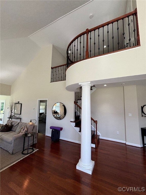 Staircase featuring ornate columns, high vaulted c