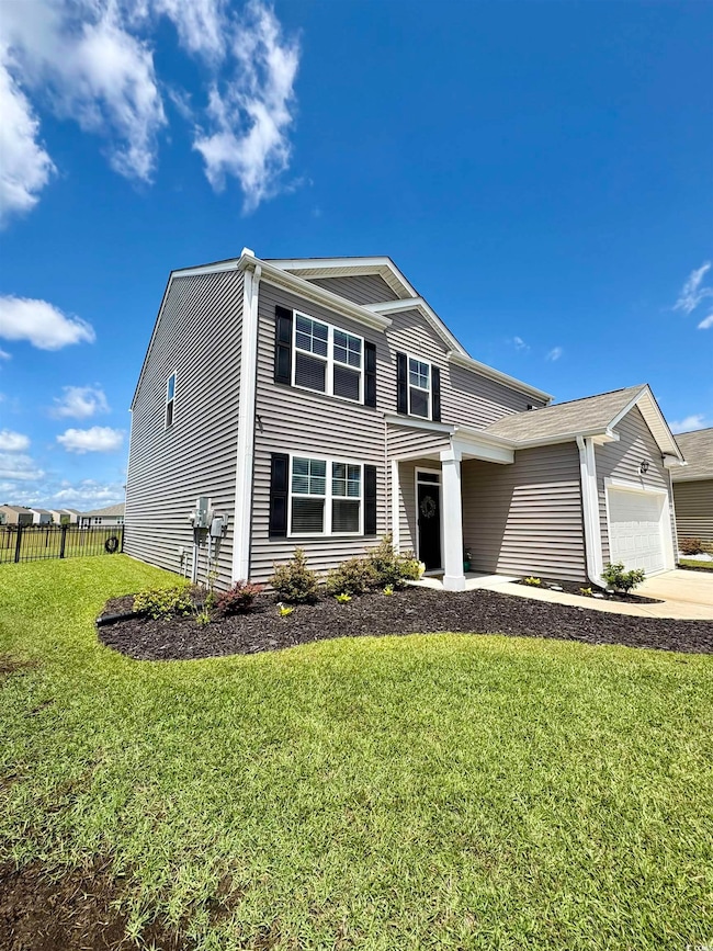 Traditional home featuring an attached garage and concrete driveway