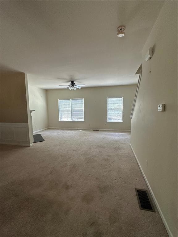Unfurnished room with ceiling fan, light carpet, b