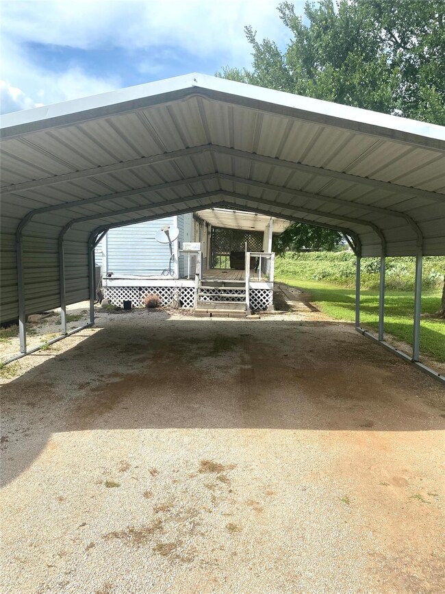 View of vehicle parking featuring a carport