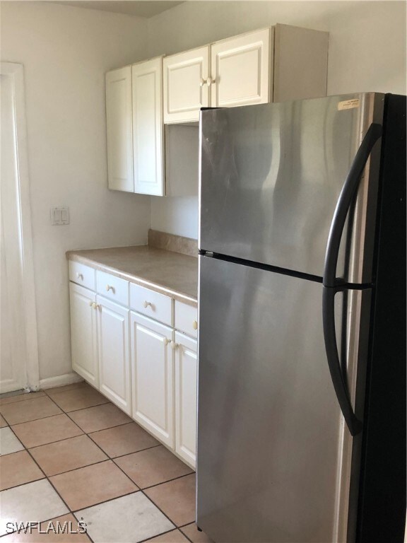Kitchen featuring light tile patterned floors, whi