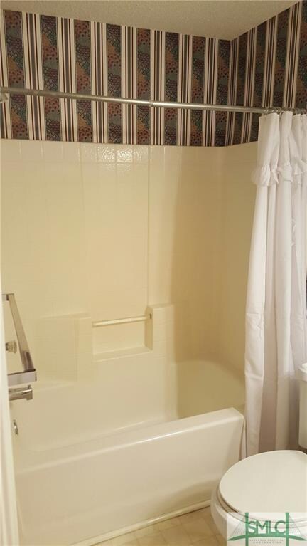 Guest full bath with shower and tub combination.
