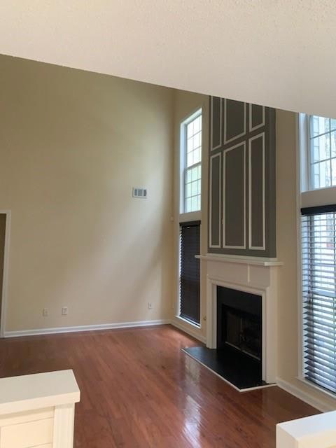living room with wood finished floors, a fireplace