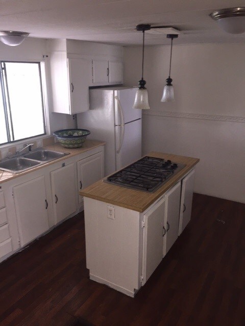 Nice island with gas range. Includes refrigerator. Needs oven.