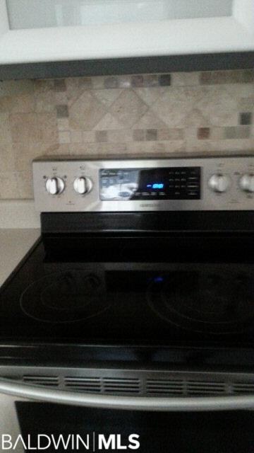 beautiful tile wall behind the stove.