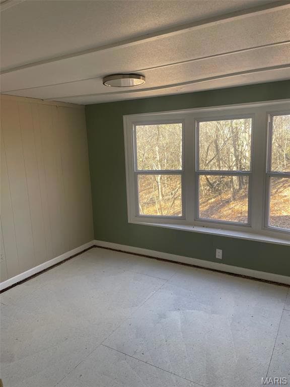 Unfurnished room with baseboards