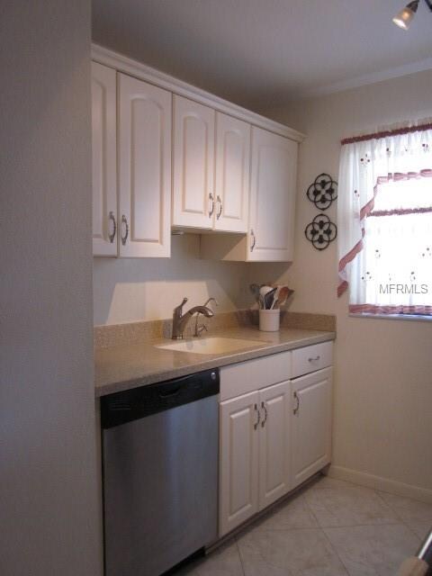 Kitchen with plenty of cabinet space and solid sur