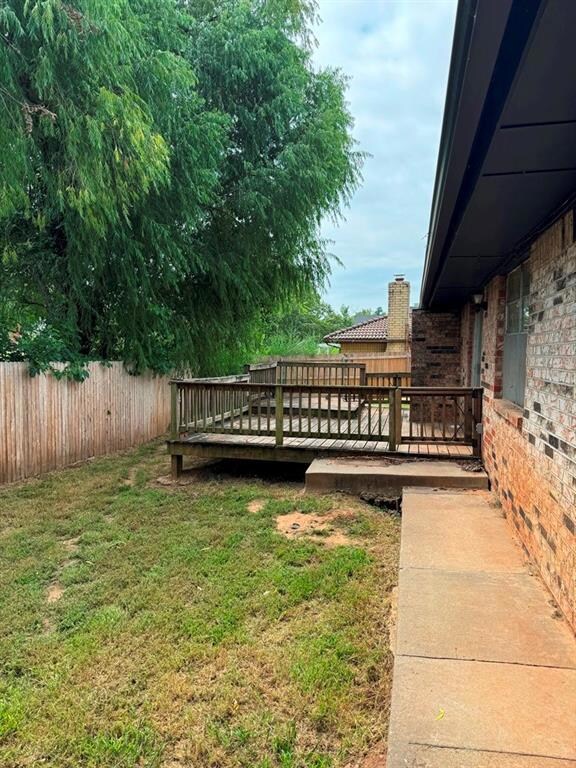 View of yard with a wooden deck