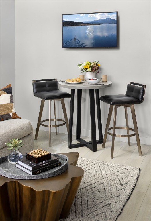 Dining area with light wood-style floors and baseboards