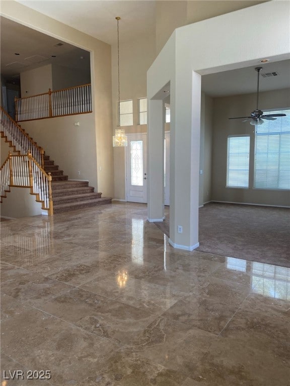 Entrance foyer with marble tiled floors, stairway,