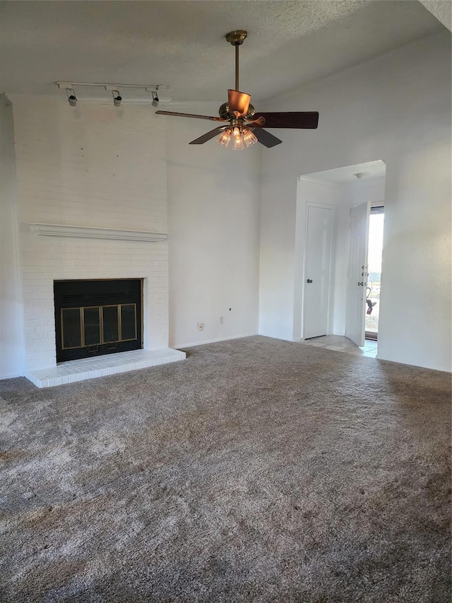 Unfurnished living room featuring track lighting, 