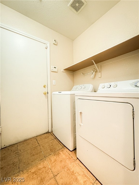 Laundry room featuring washer and clothes dryer an