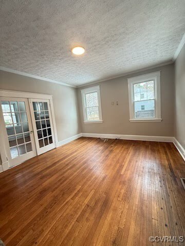 Empty room with hardwood / wood-style floors, orna