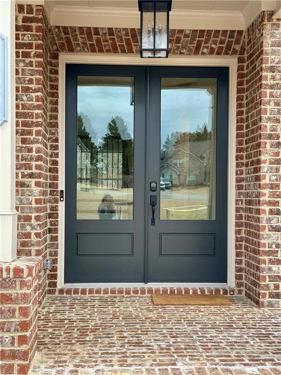 Entrance to property with brick siding