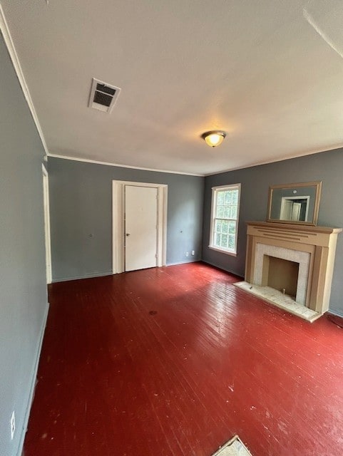 Unfurnished living room featuring a fireplace, wood finished floors, and ornamental molding