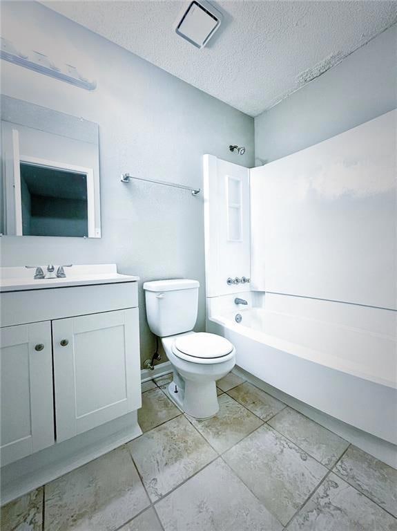 Full bathroom with toilet, vanity, shower / tub combination, and a textured ceiling
