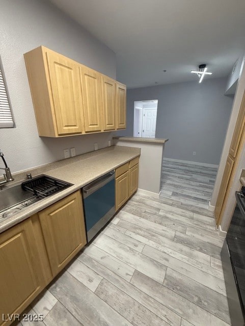 Kitchen with dishwashing machine, light brown cabinetry, light countertops, and stove