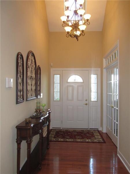 Entry with vaulted ceiling, bronze chandelier & ha