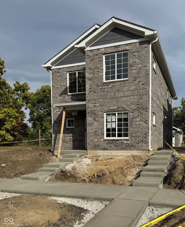 view of front of house with brick siding and a porch