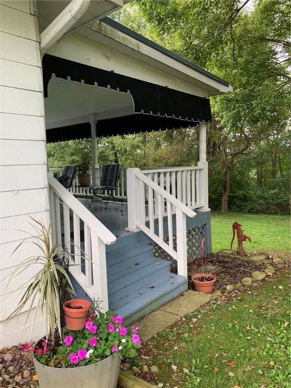 Covered, side porch to sit and relax with your mor