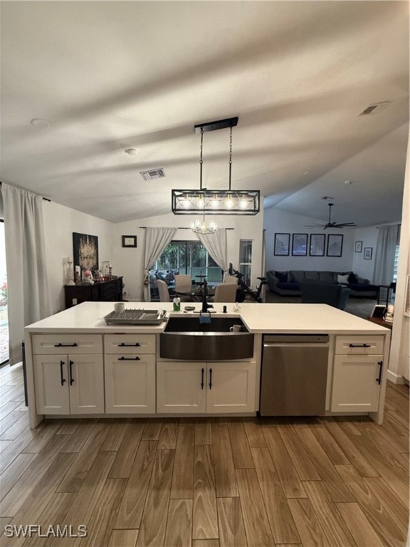 Kitchen with wood finish floors, lofted ceiling, open floor plan, and white cabinets