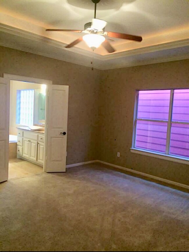 Master bedroom with coffered ceiling connects to m