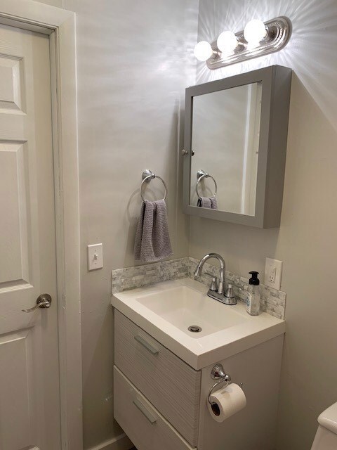 New floating vanity and tile backsplash