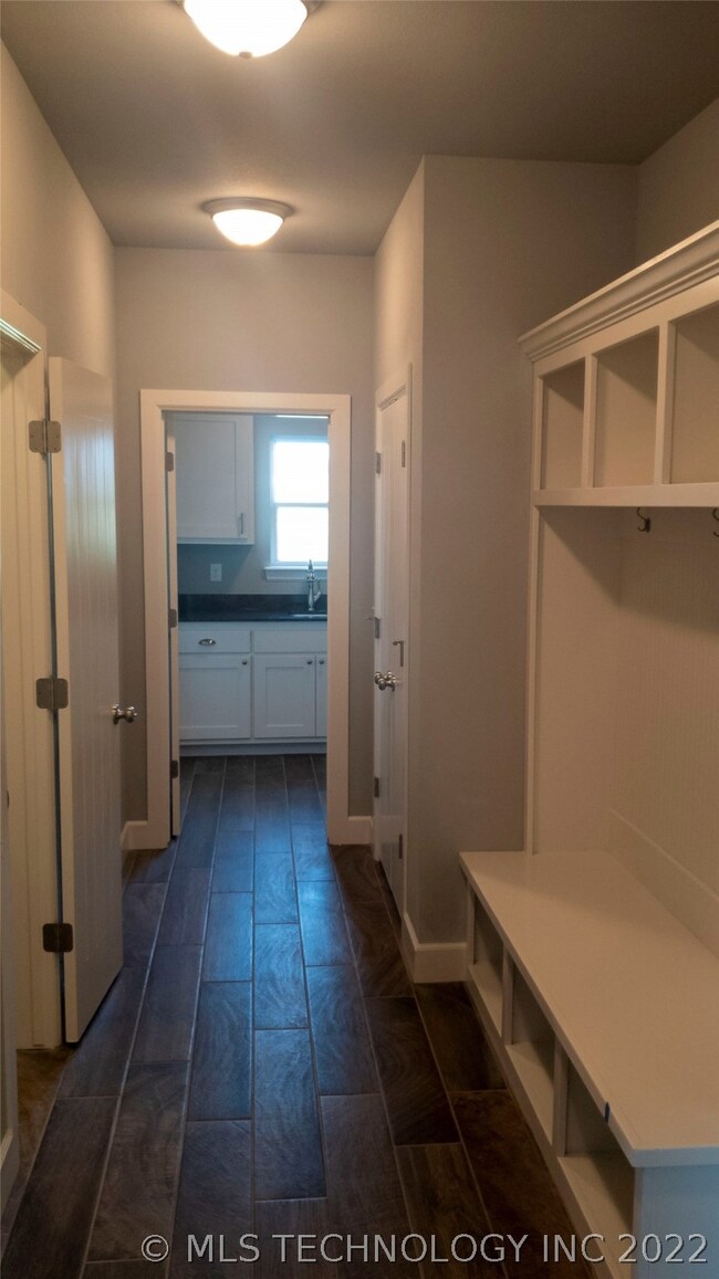 Hallway from laundry. Half bath on right, mud area