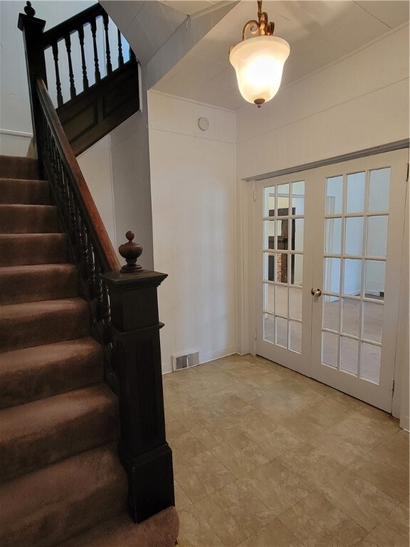 entry is spacious, french doors lead to living room