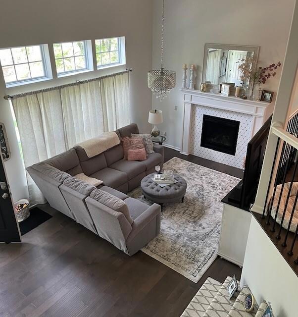 Living room featuring dark wood-type flooring and a tile fireplace