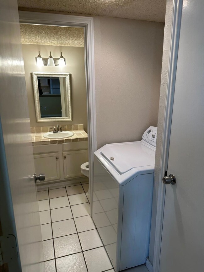 Bathroom with a textured ceiling, oversized vanity