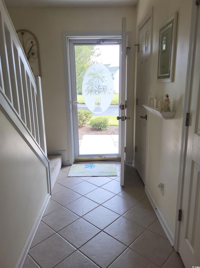 Entrance foyer featuring light tile patterned floo