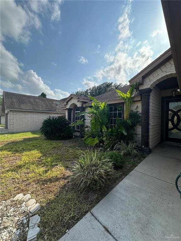 View of property exterior with a yard