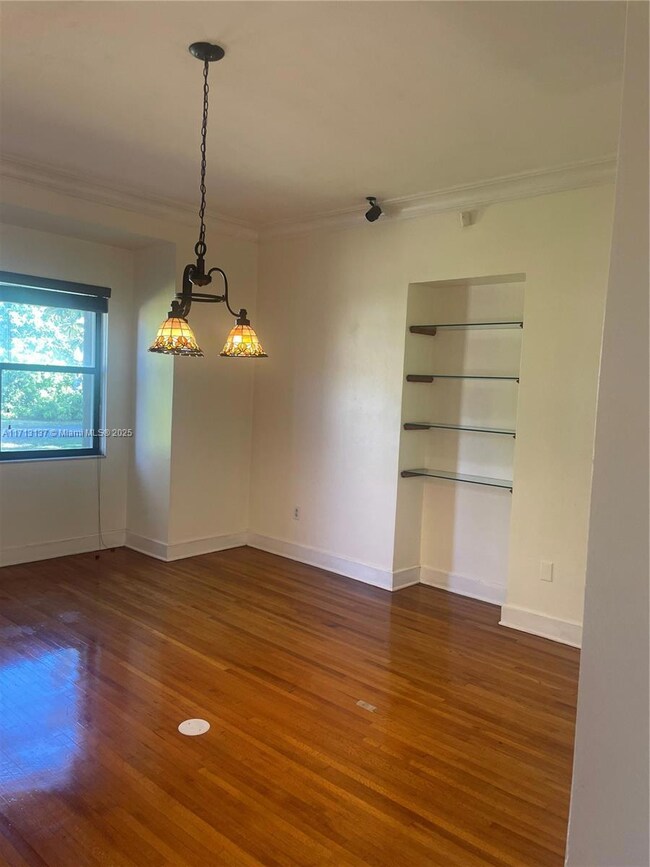 Formal dining room adjacent to kitchen and living room. Nice built in space as shown