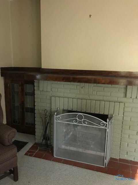 Charming fireplace with built in bookcase, glass d