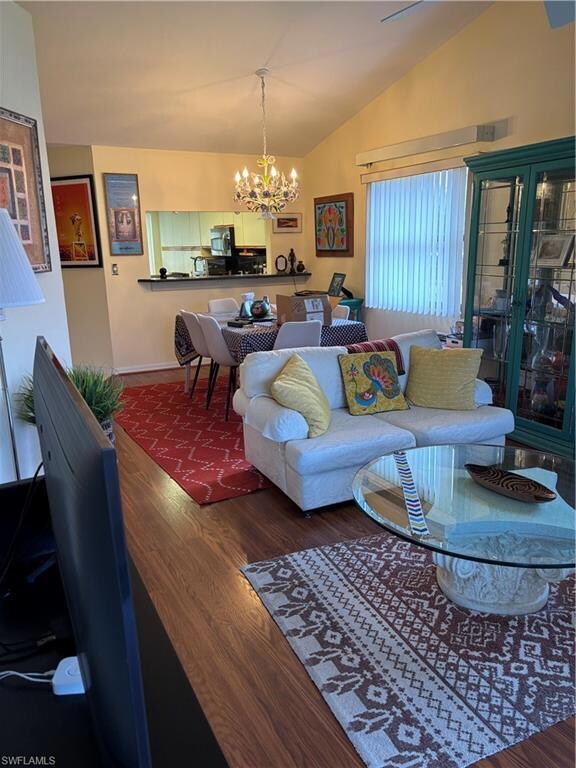 Living area featuring a chandelier, vaulted ceilin