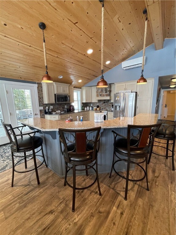 Upscale kitchen with granite countertops and stain