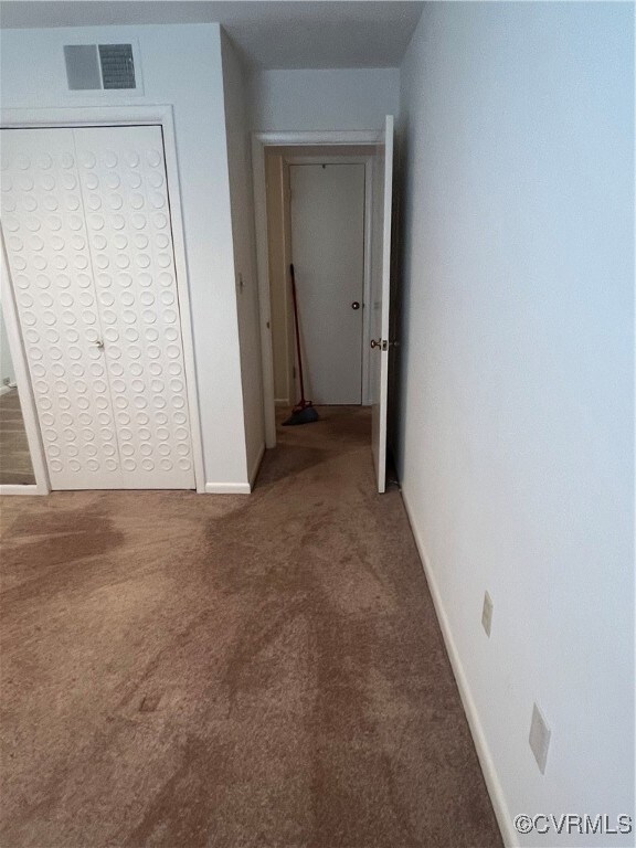 Corridor featuring carpet flooring