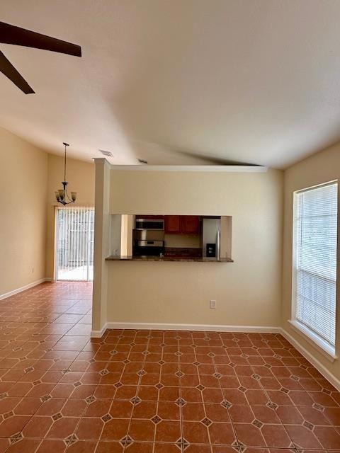 Unfurnished living room featuring a ceiling fan a