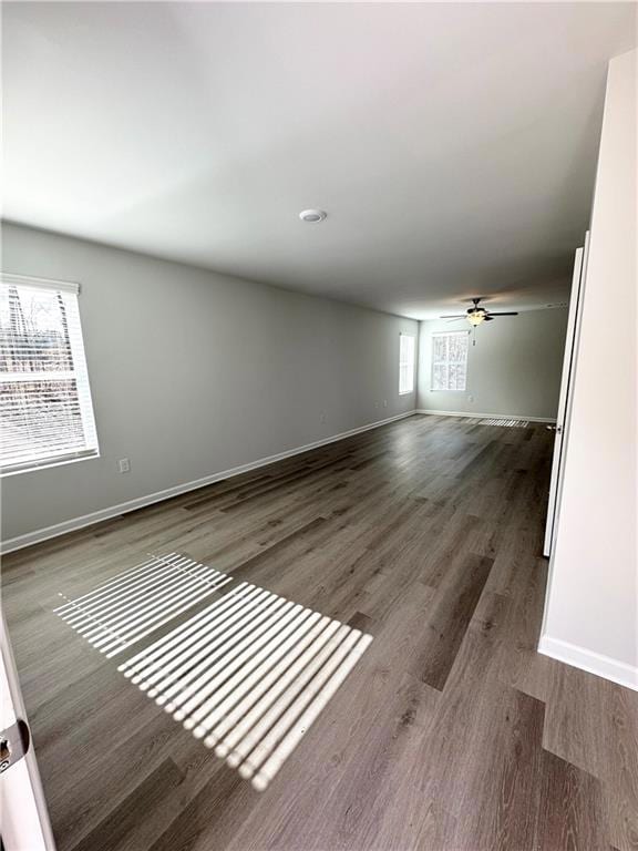 Spare room with baseboards, ceiling fan, and wood finished floors