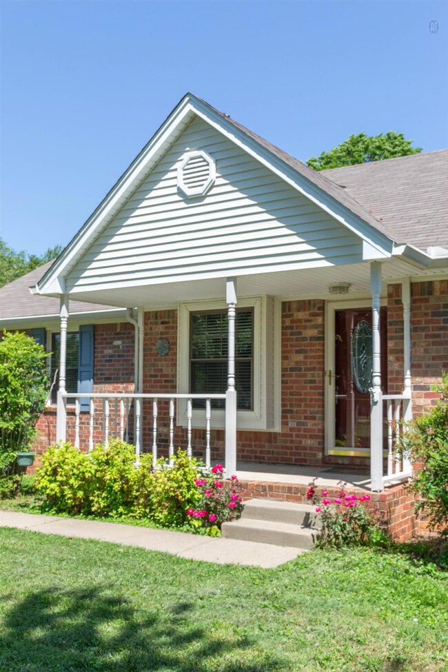 Quaint porch is ready for you to rock away those summer evenings.