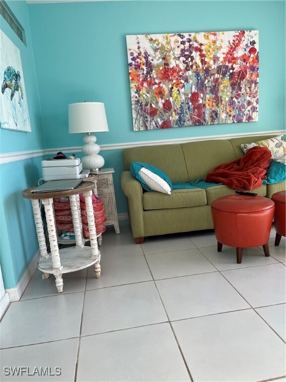 Living room featuring tile patterned floors and ba